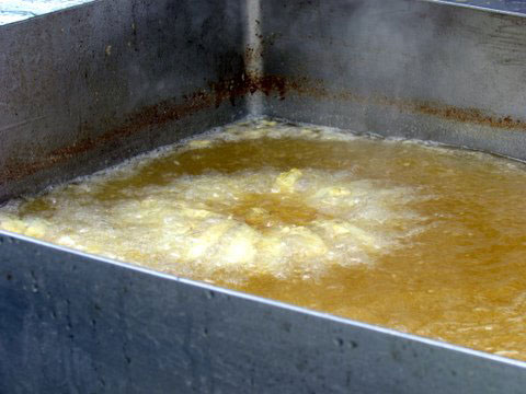 An onion boiling in oil